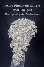 Load image into Gallery viewer, May include: A luxurious bridal bouquet with a cascade design, made from numerous sparkling rhinestones. The bouquet features floral and leaf shapes, creating an elegant design. Text on the image reads "Luxury Rhinestone Cascade Bridal Bouquet".