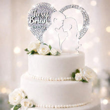 Load image into Gallery viewer, May include: A white, three-tiered wedding cake adorned with white roses and a heart-shaped cake topper. The topper displays the names "Jusy" and "Brian" with the date "09.09.25" and a couple's silhouette.