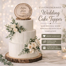 Load image into Gallery viewer, May include: A three-tiered white wedding cake with a wooden cake topper engraved with names and a date. The cake is decorated with white roses and greenery. The cake sits on a wooden base. Text on the image reads "Custom Engraved Wedding Cake Topper".
