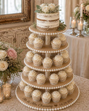 Load image into Gallery viewer, Rustic 5 tier MDF wedding cake and dessert stand with large white pearl edging and pearl-covered centre supports. Displayed in a warm barn wedding setting with a semi-naked cake on top, brownies, cookie bars and cupcakes on the lower tiers. Includes a size guide showing 10cm between each tier and diameters from 25cm to 45cm.
