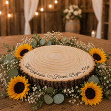 Load image into Gallery viewer, Rustic log slice cake stand with personalised engraving, natural wood grain and bark edge for wedding dessert table styling. Natural wooden wedding cake stand.Handmade wooden cake stand with engraved couple names and wedding date, ideal for rustic, woodland or country wedding cakes.

