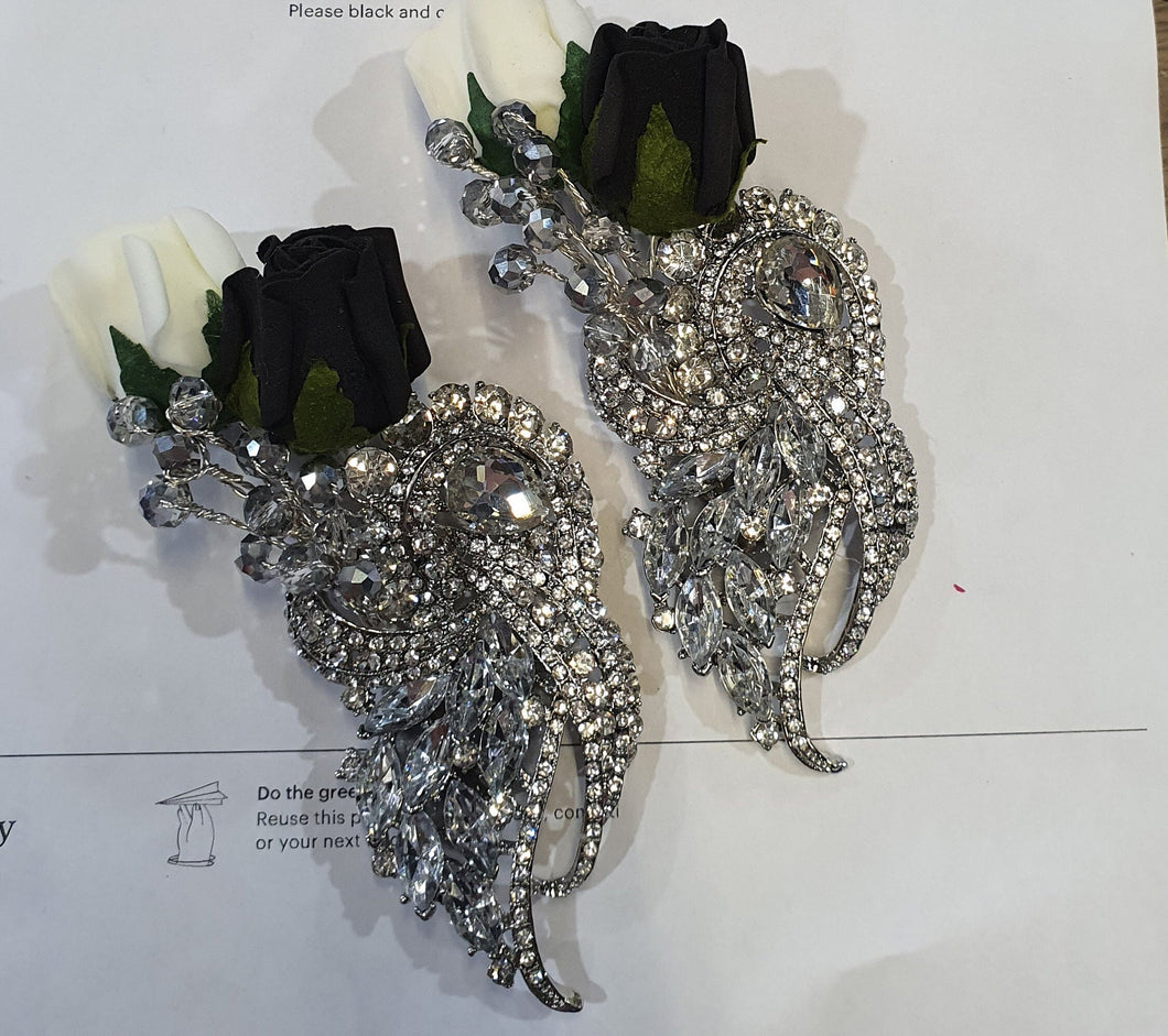 Crystal brooch  buttonhole  with  ivory and black foam roses by Crystal wedding uk
